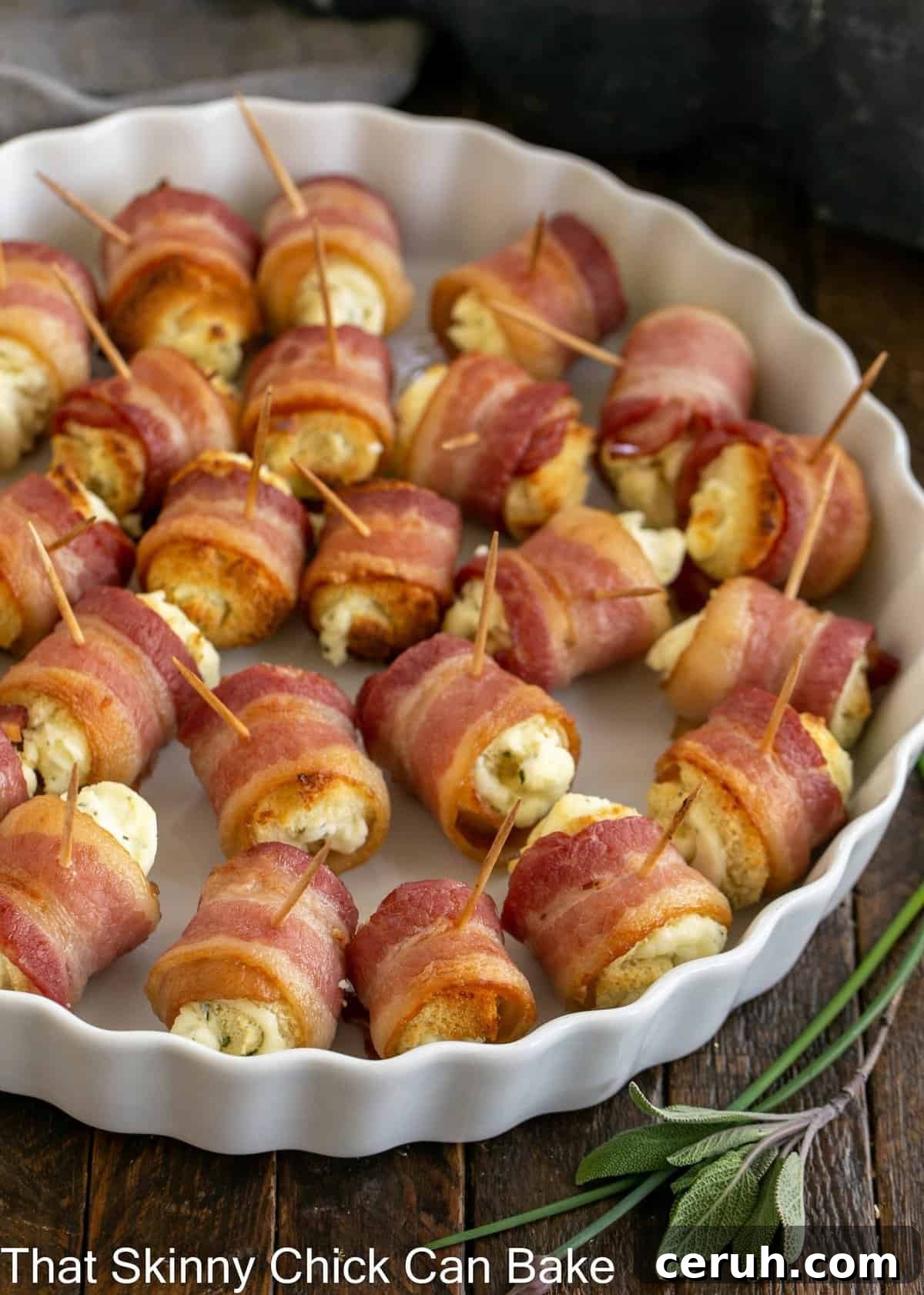 Overhead view of bacon and cheese rolls in a rimmed, white serving dish.