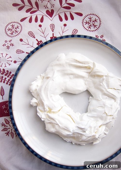Pavlova wreath topped with cream