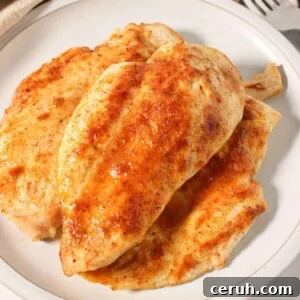 Thinly sliced chicken breast piled on a plate.