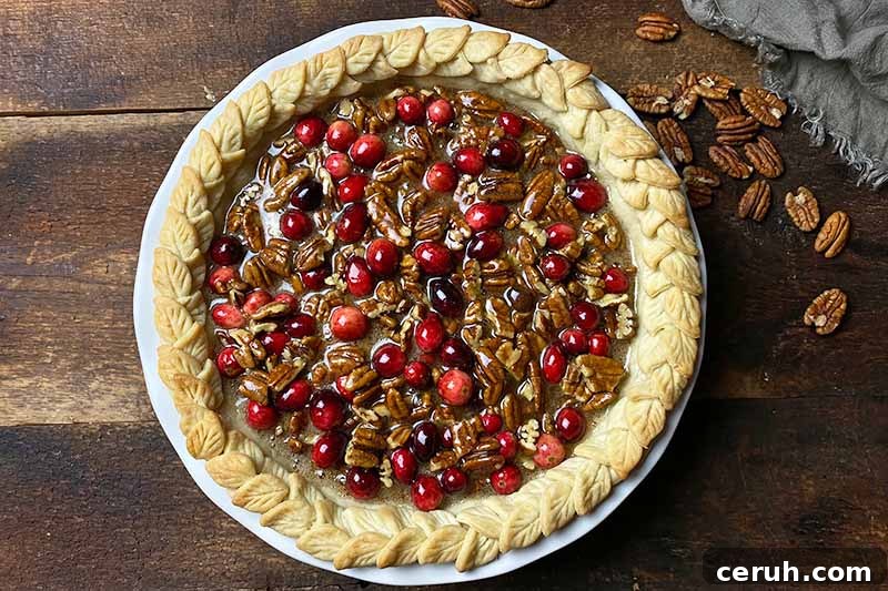 Horizontal image of an unbaked pastry with decorative crust.