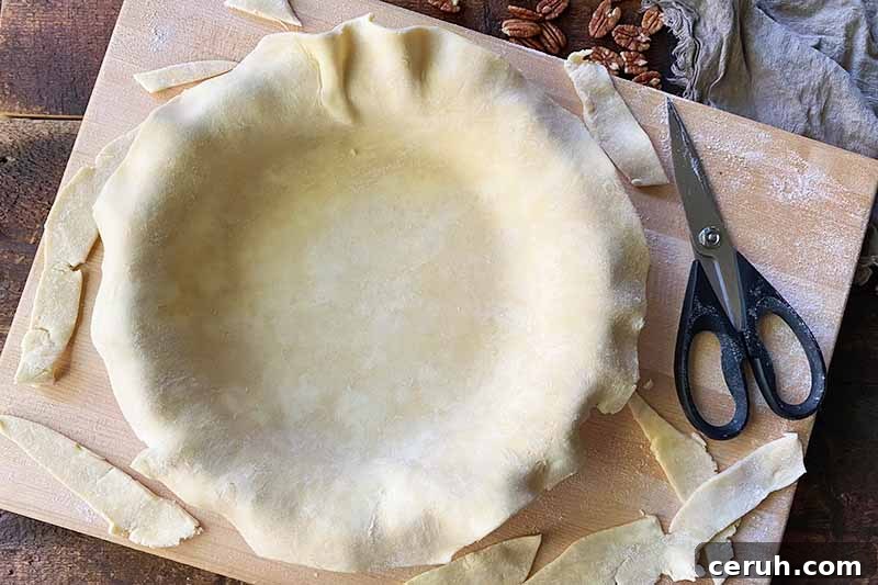 Horizontal image of forming dough into a casserole dish.