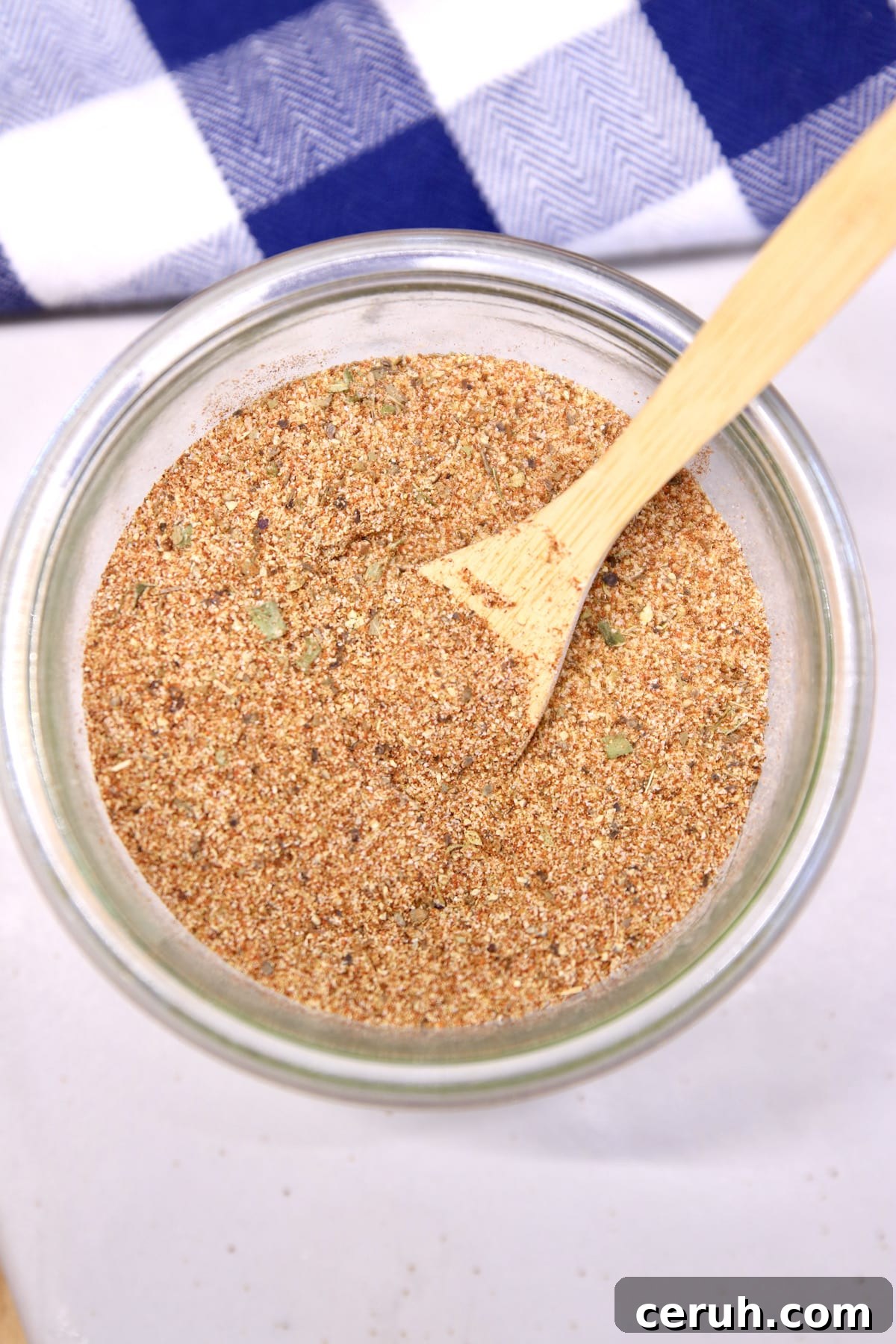 Bowl of Creole Seasoning Blend. Bowl of homemade Creole seasoning with a wood spoon.
