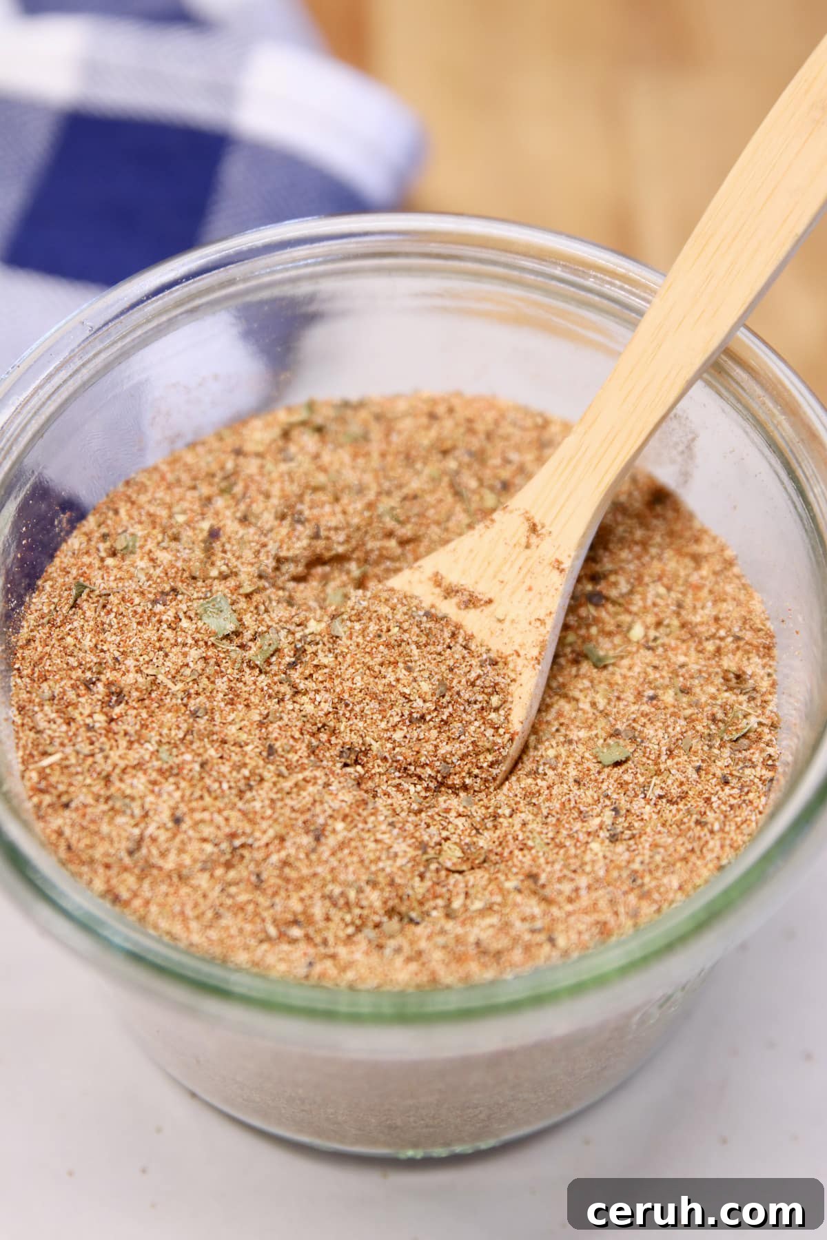 Creole Spice Blend in a jar. Bowl of Creole spices with wood spoon.