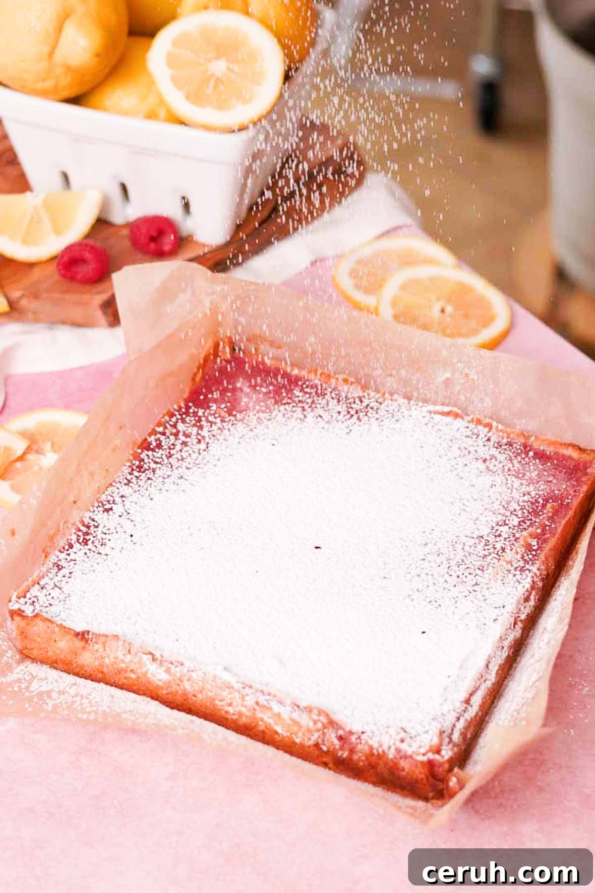 sprinkling lemon bars with powdered sugar