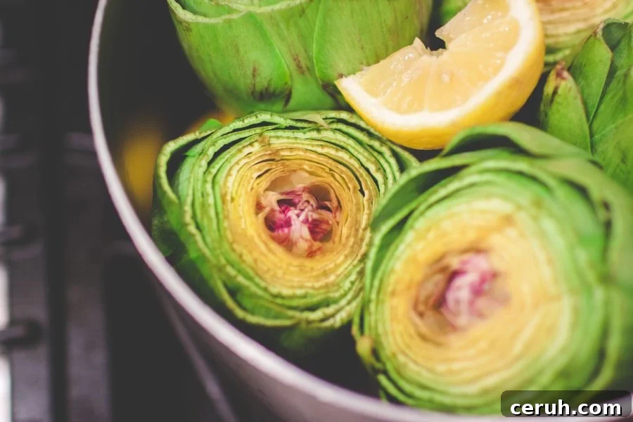 Fresh artichokes steaming in pot.