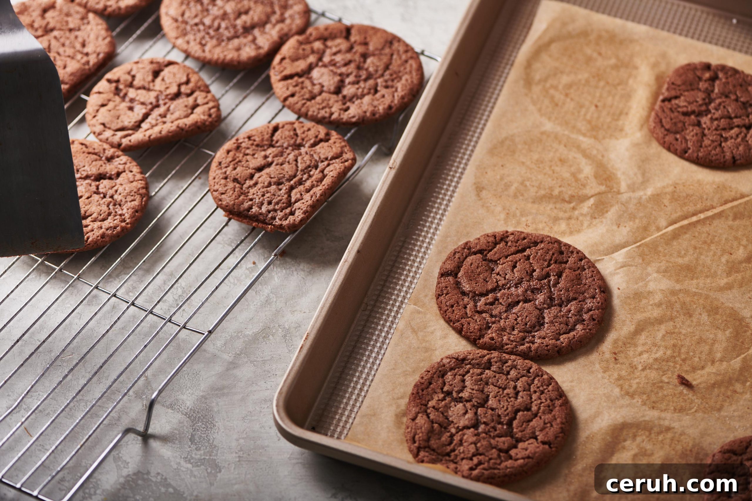 Baked Mexican Hot Chocolate Cookies on a baking sheet and a cooling rack.
