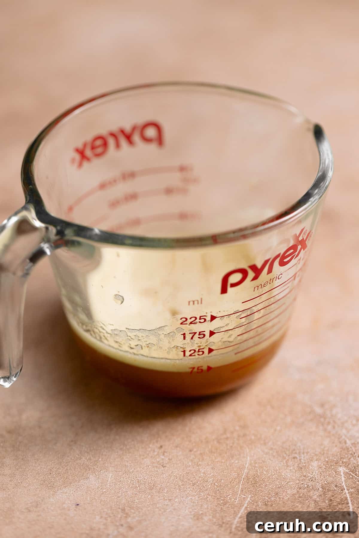 Brown butter in a glass pyrex measuring cup.