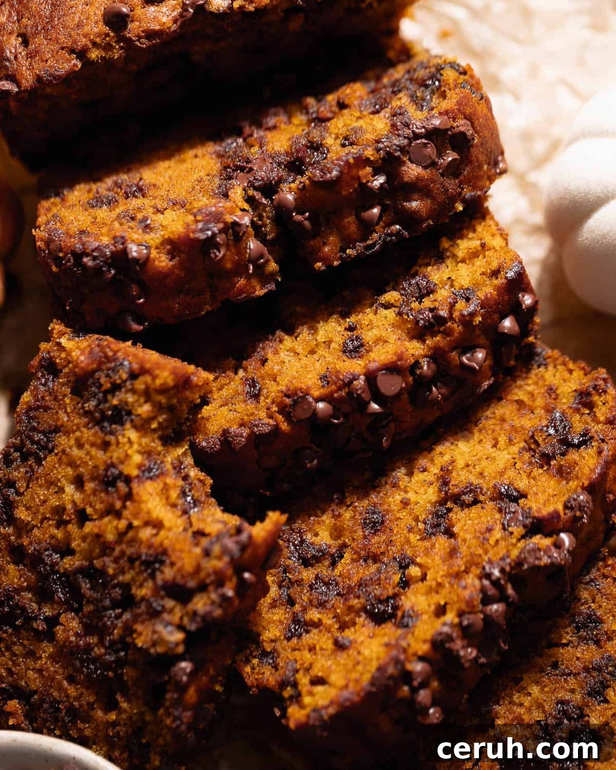 Slices of chocolate chip pumpkin bread laying on top of each other.