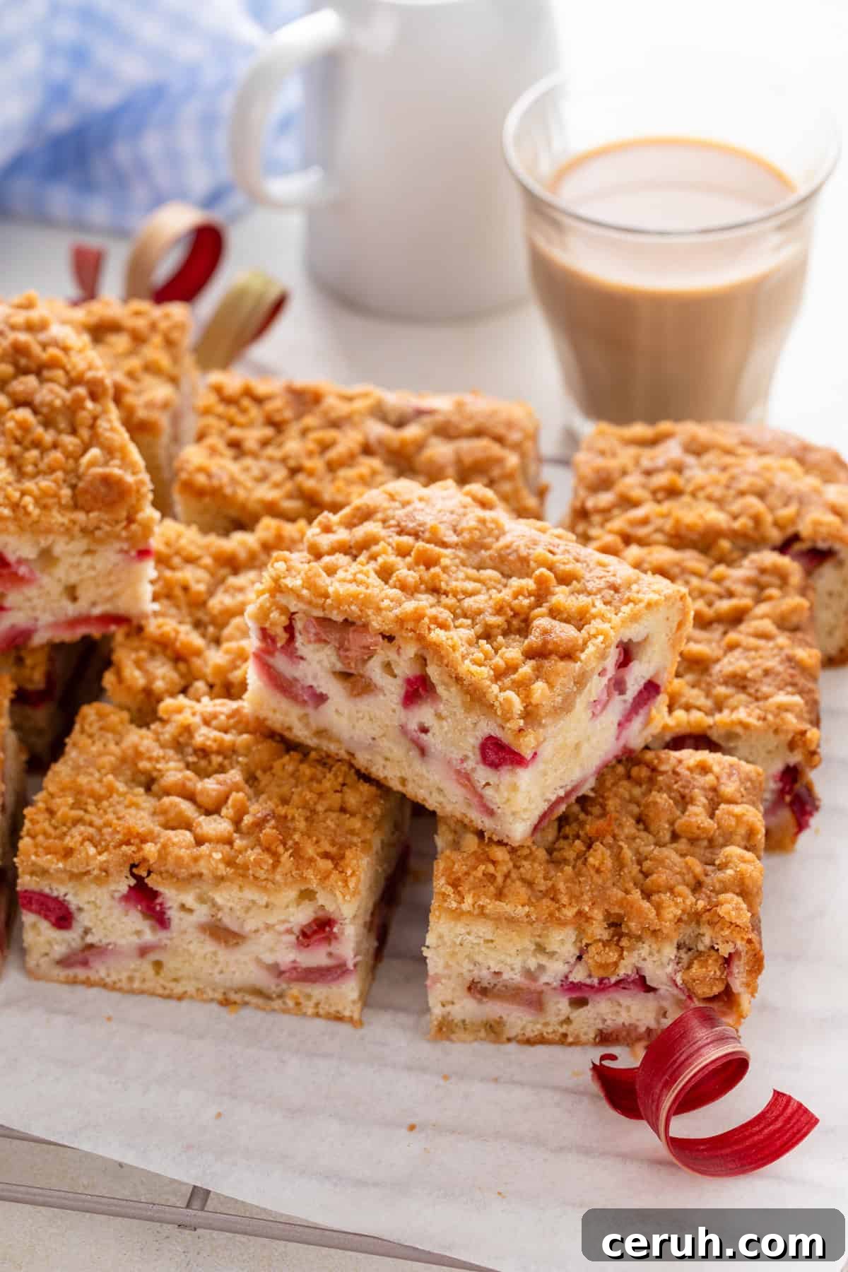 Slices of rhubarb cake arranged on a piece of parchment paper.