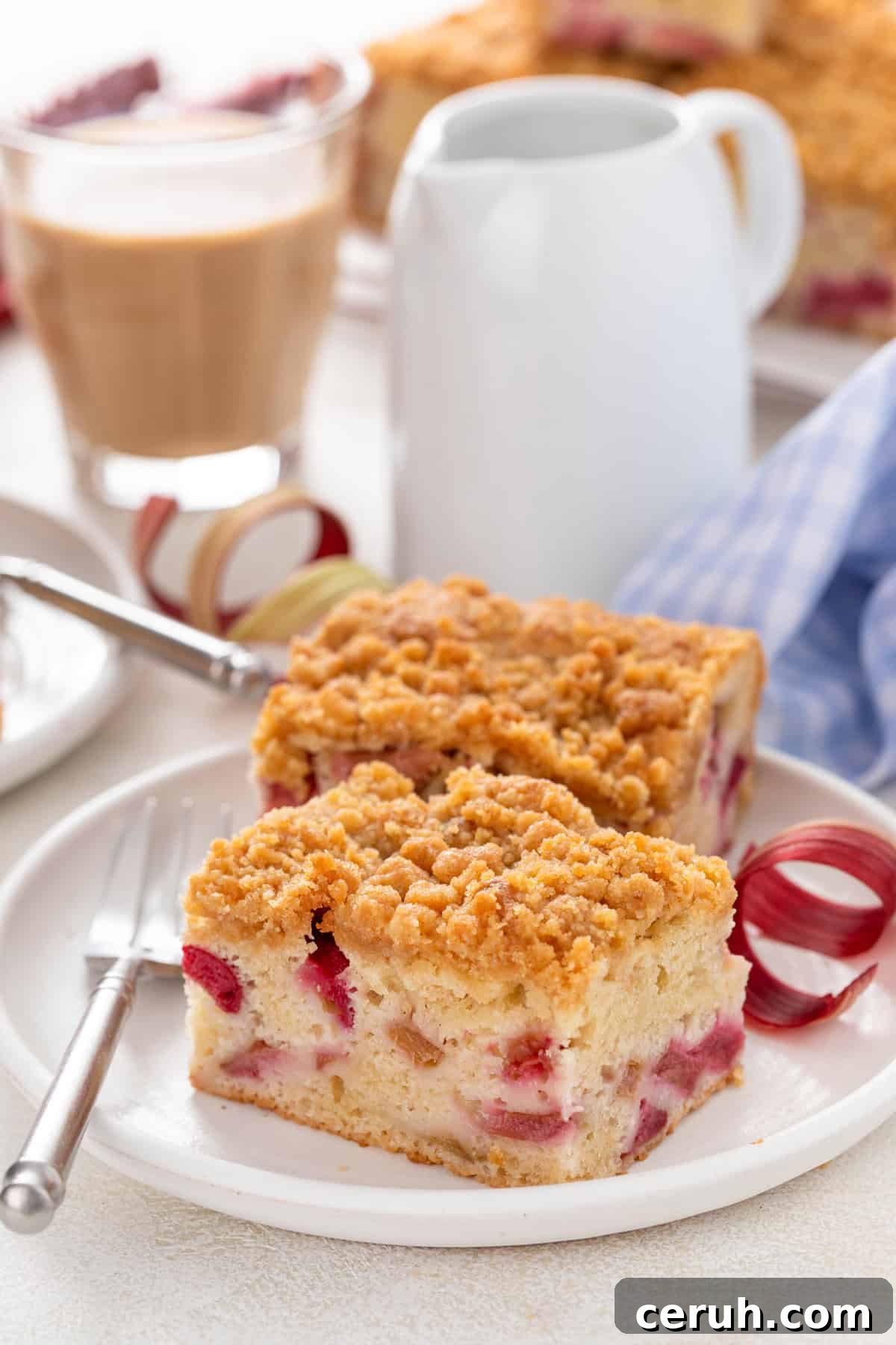 Two slices of rhubarb cake on a white plate.