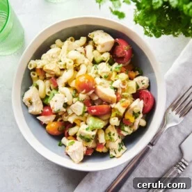 Table setting with a bowl of Pasta Salad with Chicken and a cloth napkin.