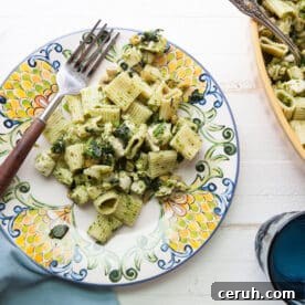Chicken pasta salad with ramp vinaigrette on colorful plate.