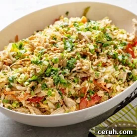 Indonesian Chicken Salad in white serving bowl on table.