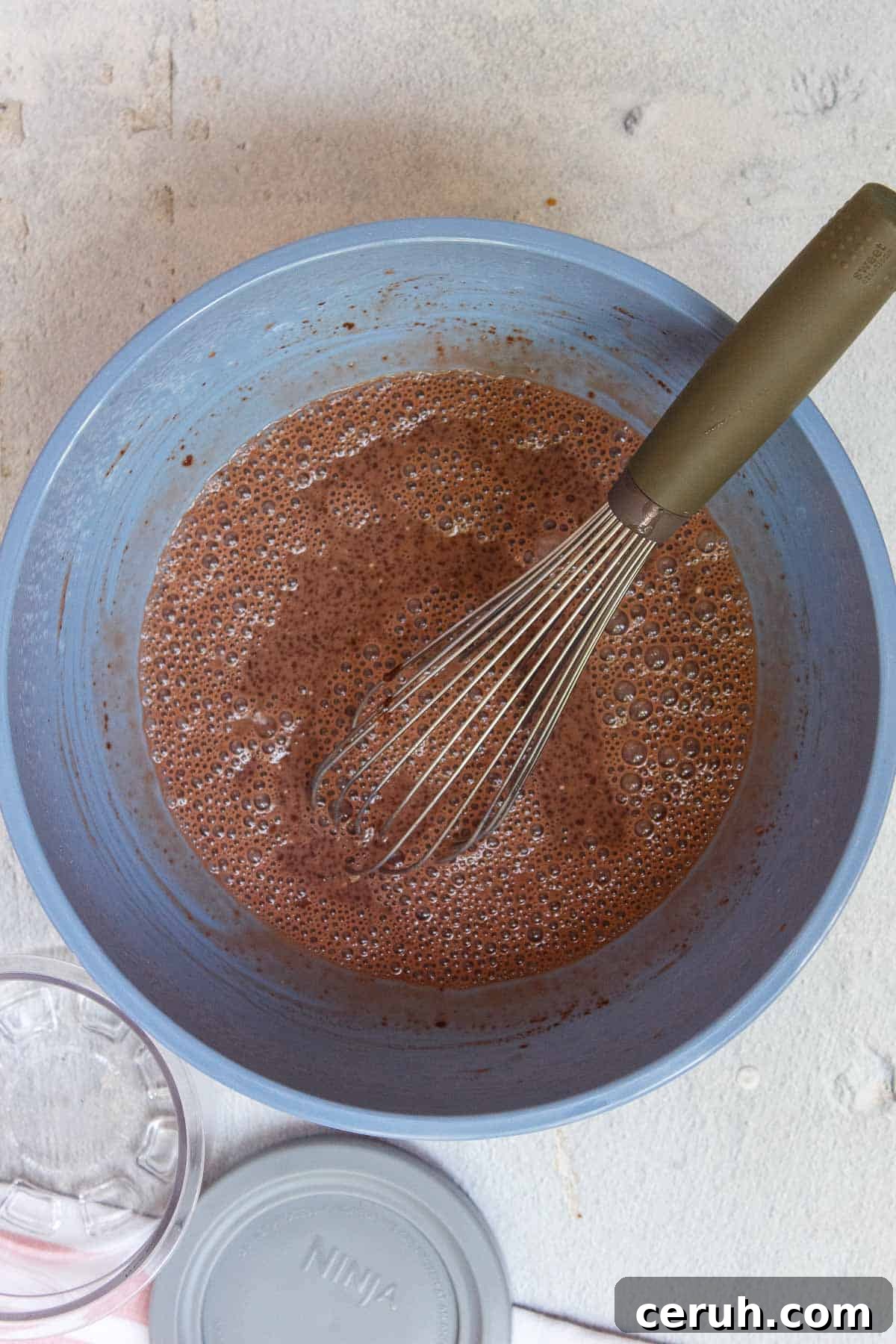 Ninja Creami Chocolate Protein Ice Cream liquid mixture sitting while the bubble settle