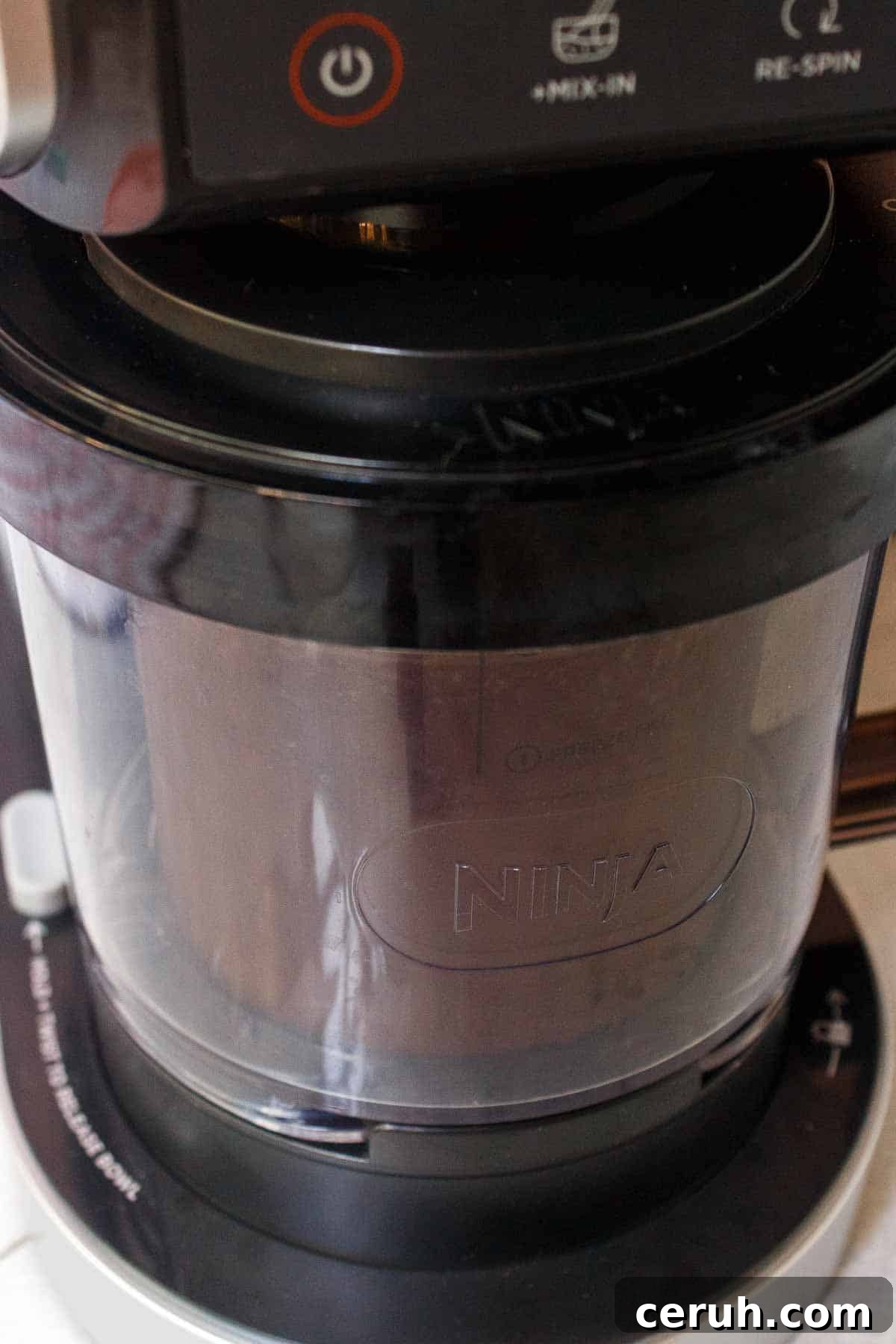Ninja Creami machine loaded with a pint of ice cream