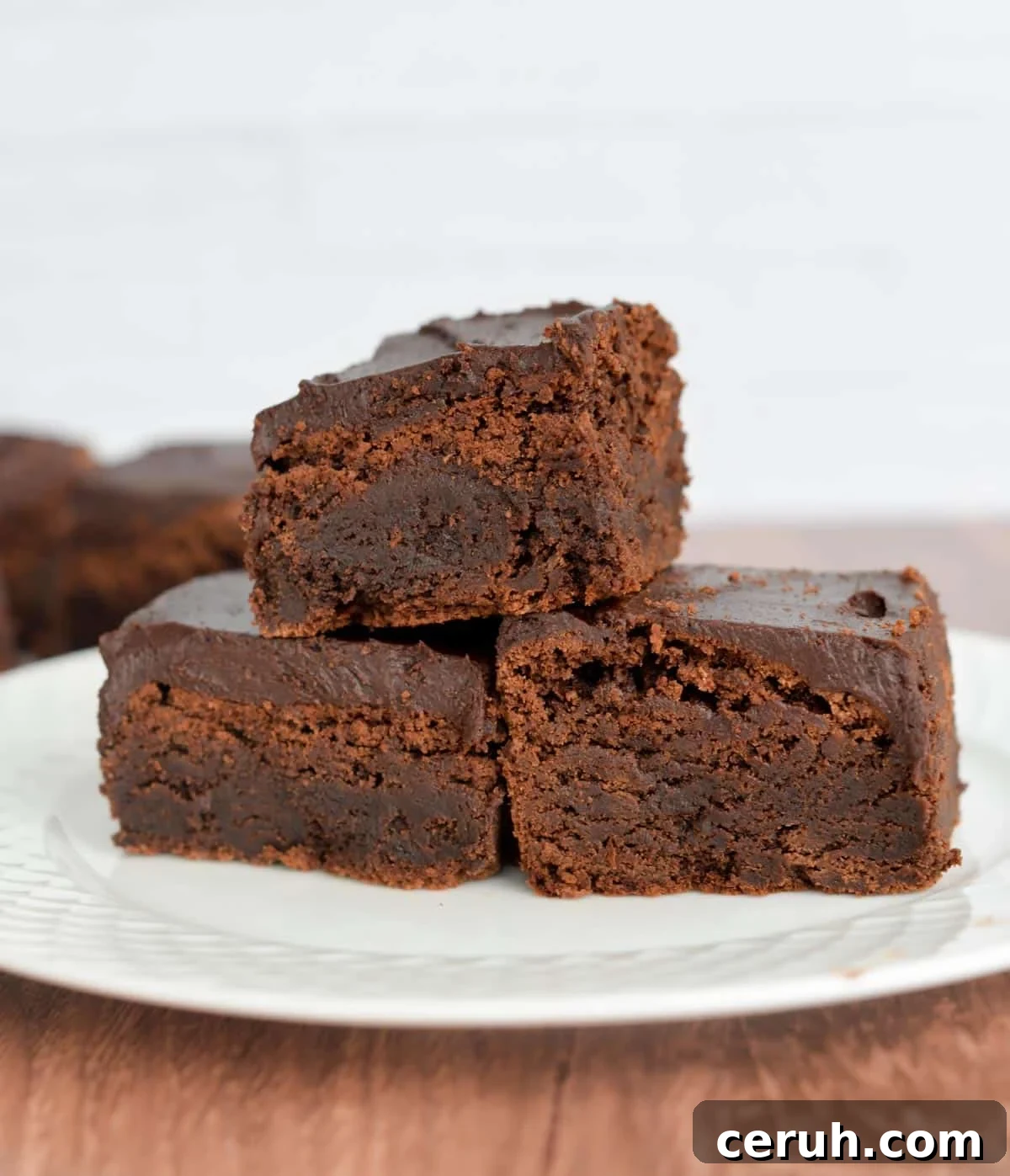A stack of sourdough brownies on a plate.