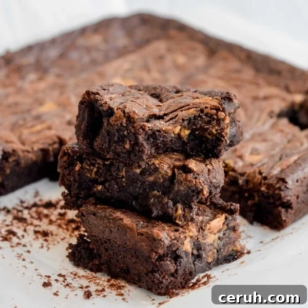 Three chocolate sourdough peanut butter brownies stacked on top of each other.