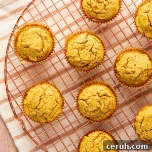 A wire rack with cornbread muffins on it.