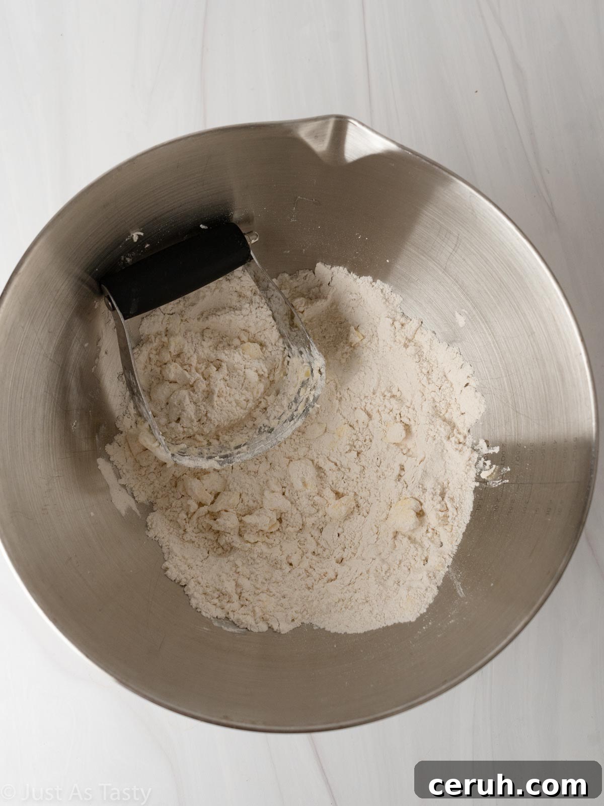 Dry ingredients with butter in a bowl.