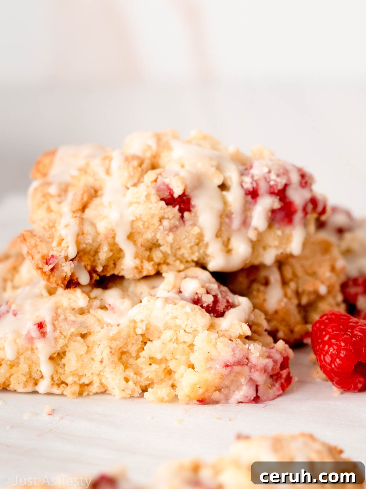 White chocolate raspberry scones stacked on top of each other.