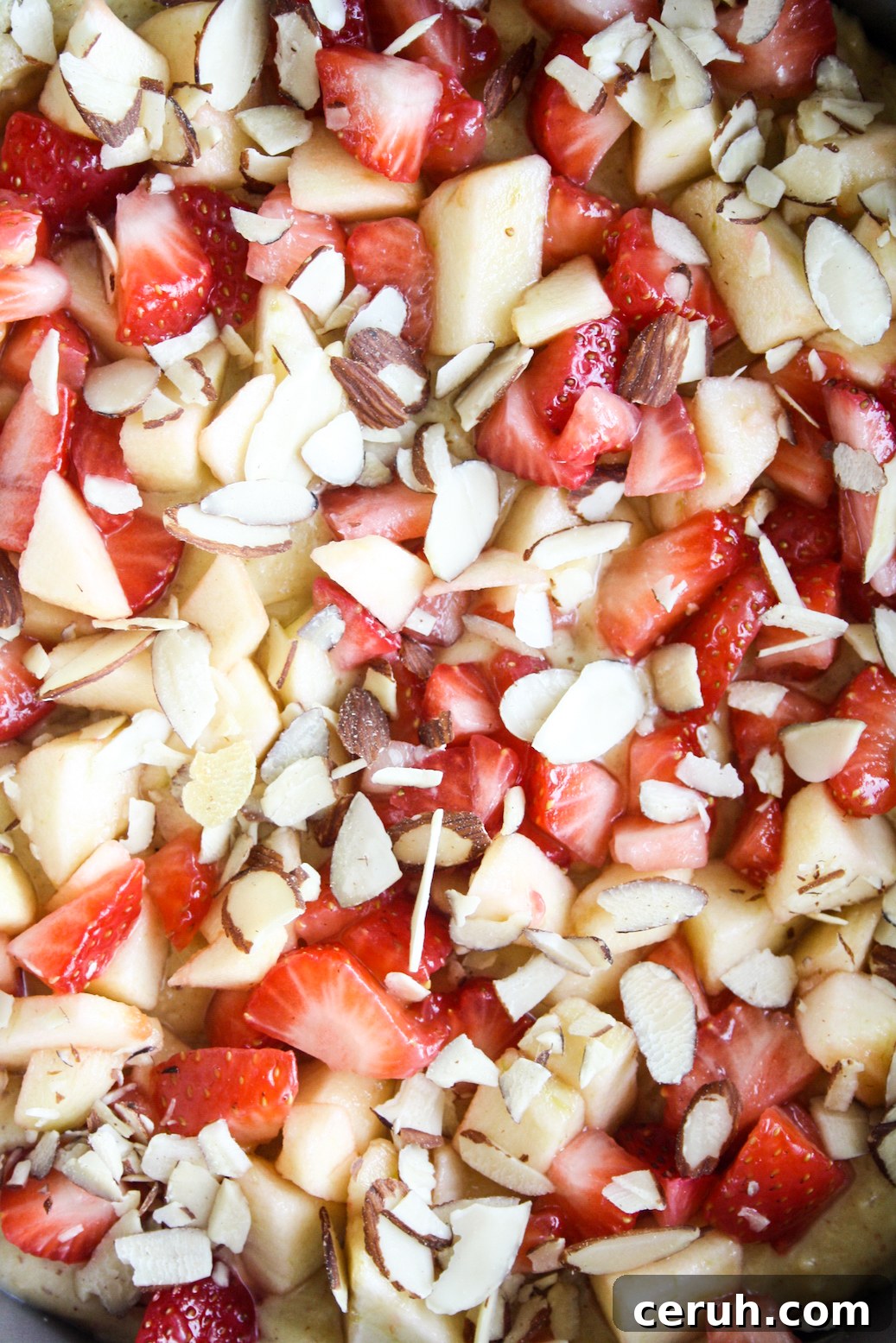 Tender almond and browned butter cake topped with fresh apples and strawberries