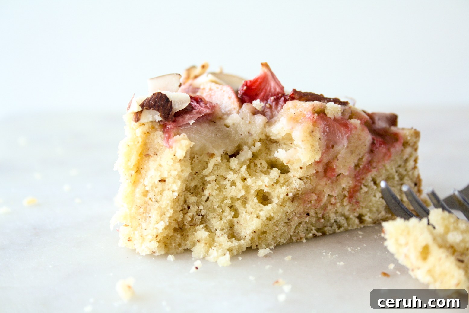 Tender almond and browned butter cake topped with fresh apples and strawberries