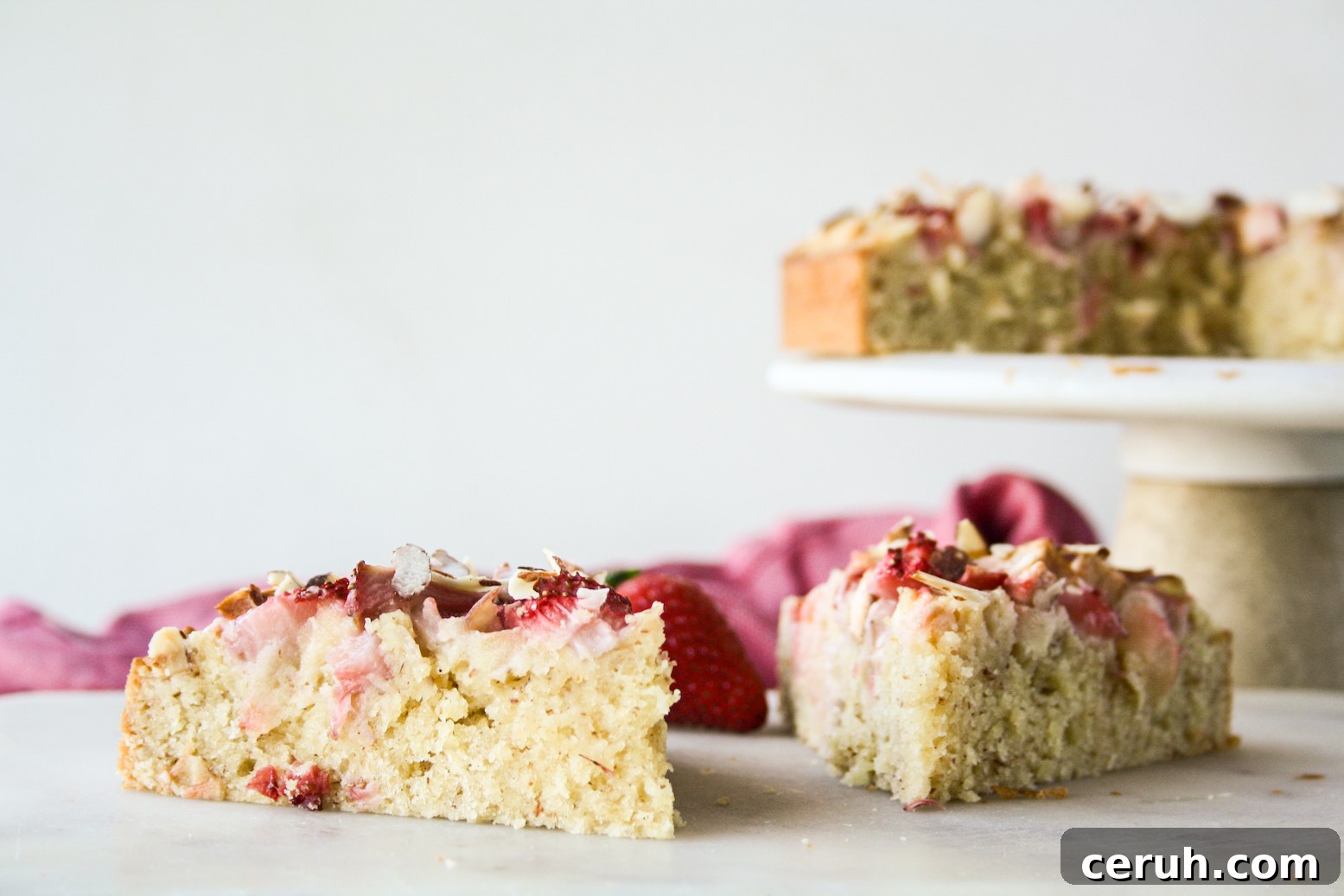 Tender almond and browned butter cake topped with fresh apples and strawberries