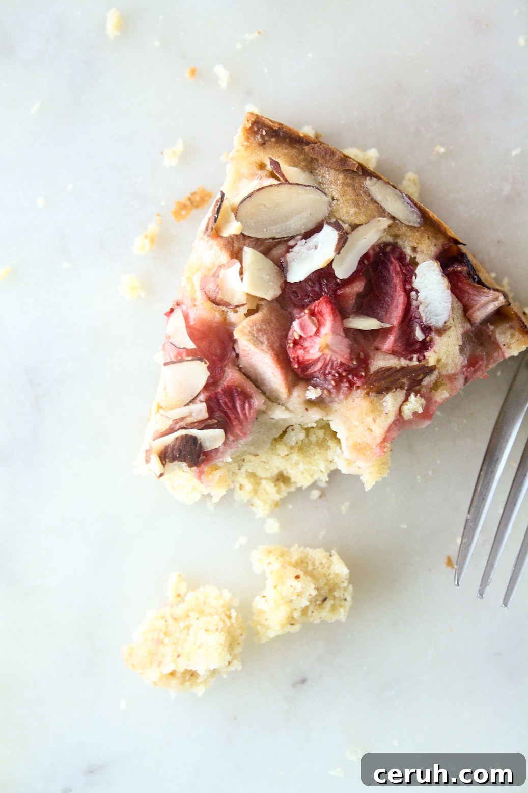 Tender almond and browned butter cake topped with fresh apples and strawberries
