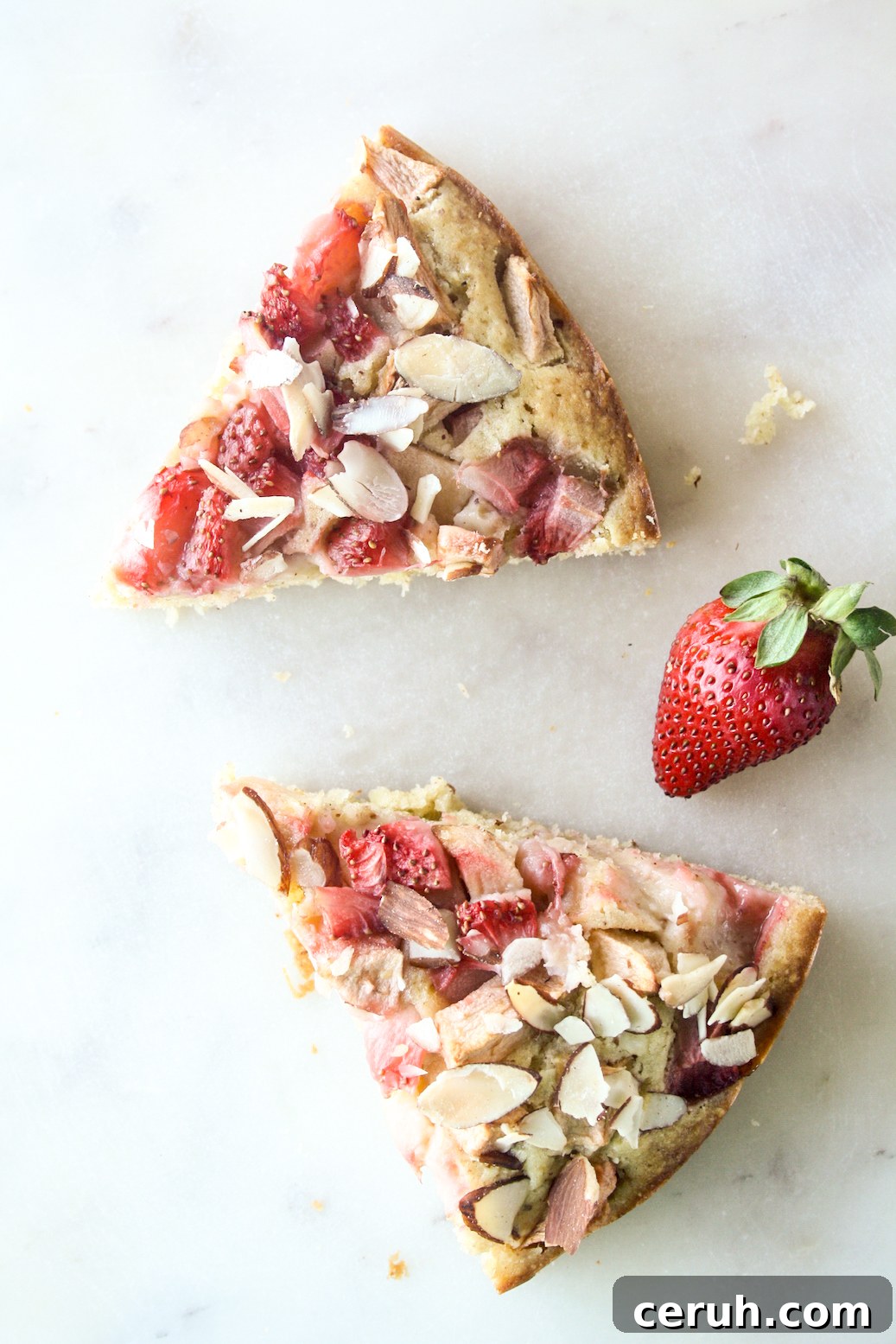 Tender almond and browned butter cake topped with fresh apples and strawberries