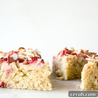 Tender almond and browned butter cake topped with fresh apples and strawberries