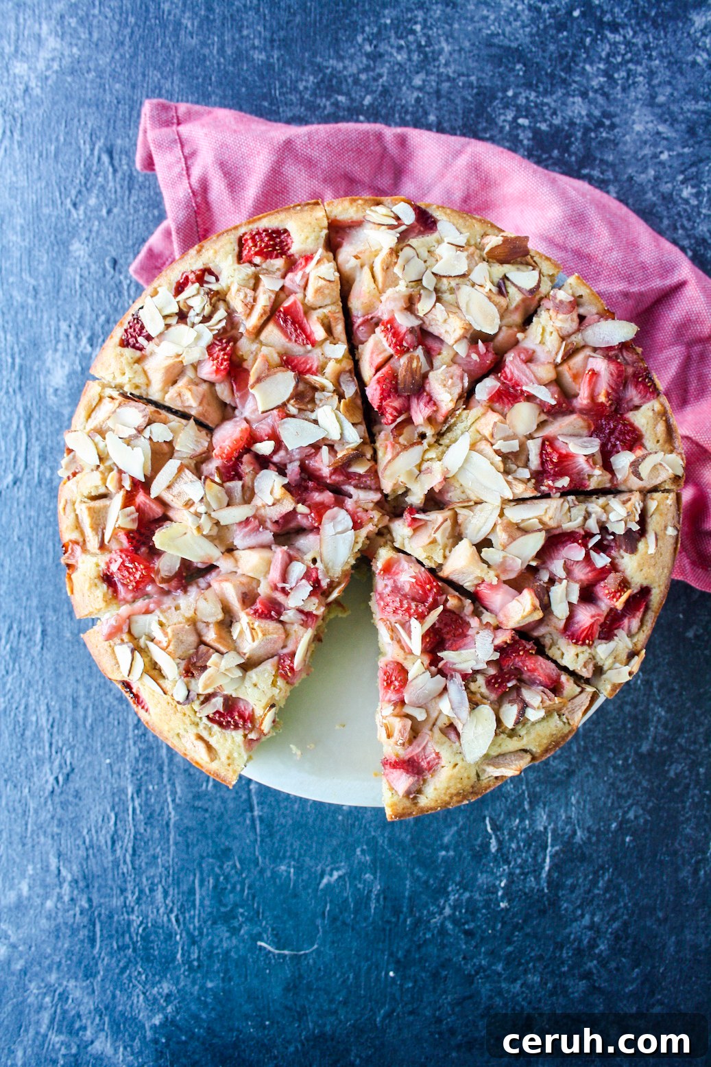 Tender almond and browned butter cake topped with fresh apples and strawberries