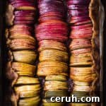 Spiced rainbow apple galette with purple, red, pink, orange and green apple slices.