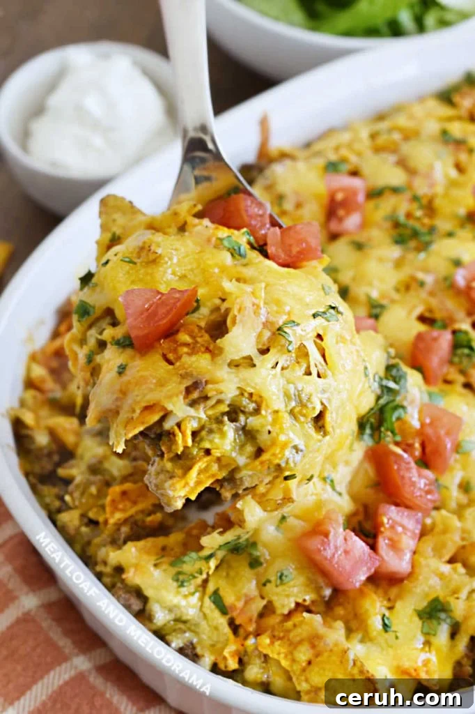 doritos ground beef and cheese casserole on a serving spoon