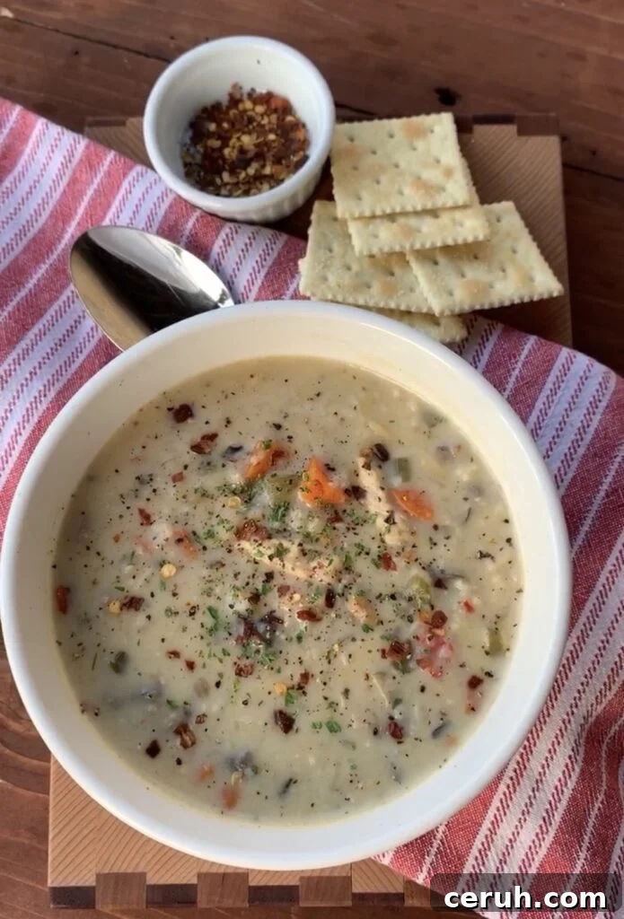 Creamy chicken and wild rice soup with Saltine crackers