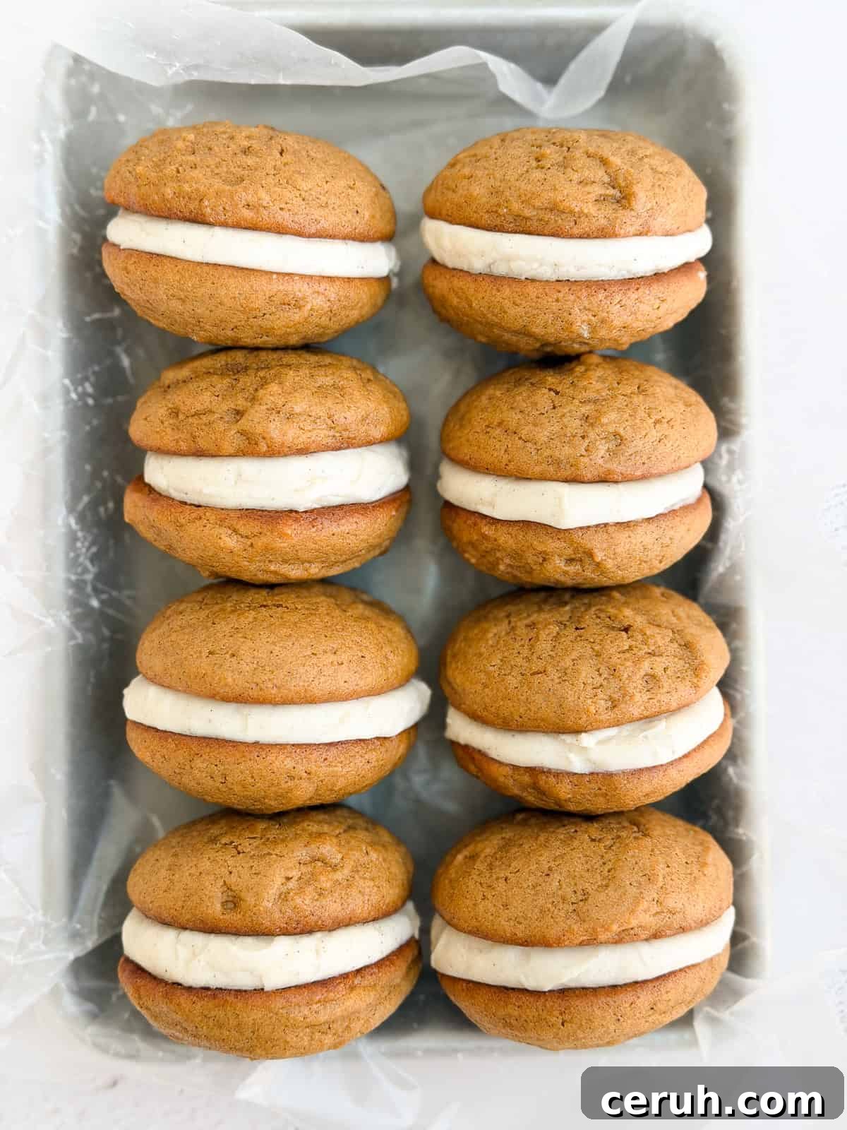 a bunch of gingerbread whoopie pies stacked together.