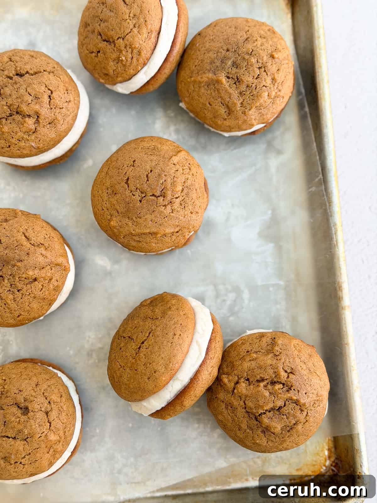 all the whoopee pies scattered on a baking sheet.