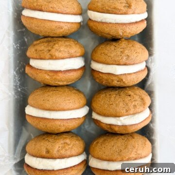 a bunch of gingerbread whoopie pies stacked together.