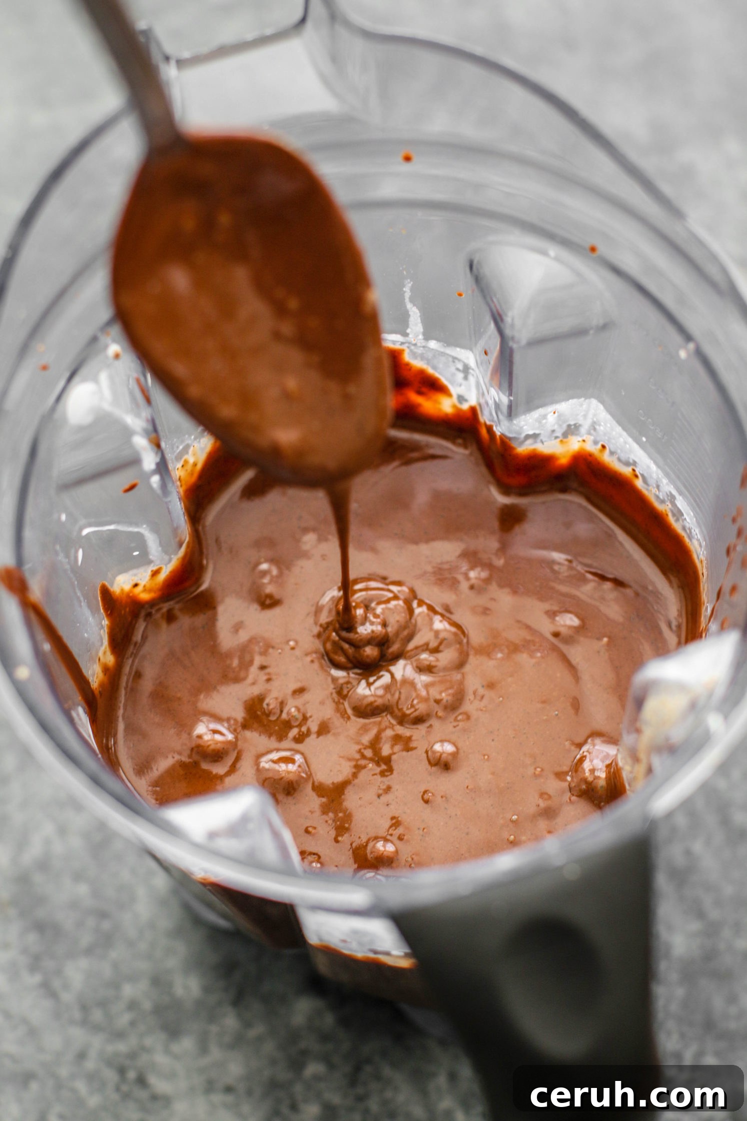 chocolate mousse in blender with spoon by Flora & Vino