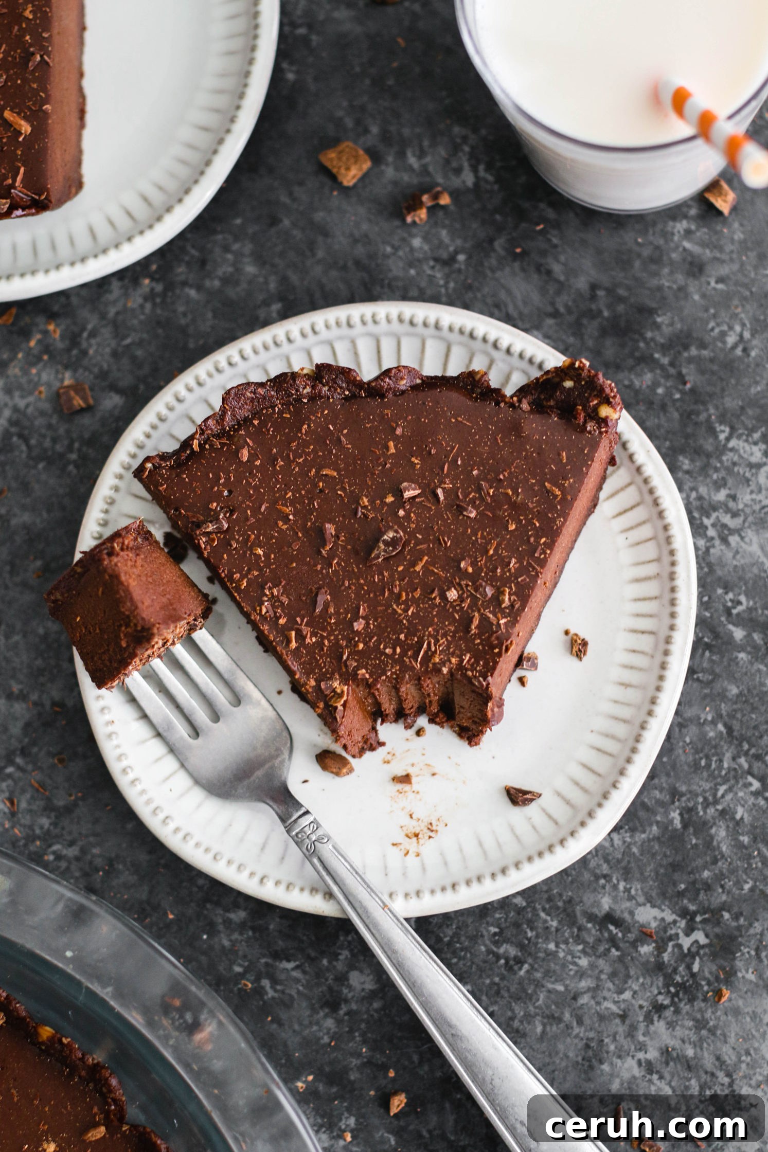 slice of Vegan Chocolate Pie with a fork removing one bite by Flora & Vino