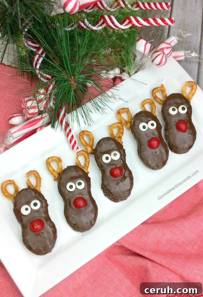 Reindeer Nutter Butter Treats on a serving plate, with Christmas decorations around