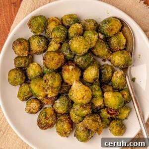 Brussels sprouts with a serving spoon on a plate.