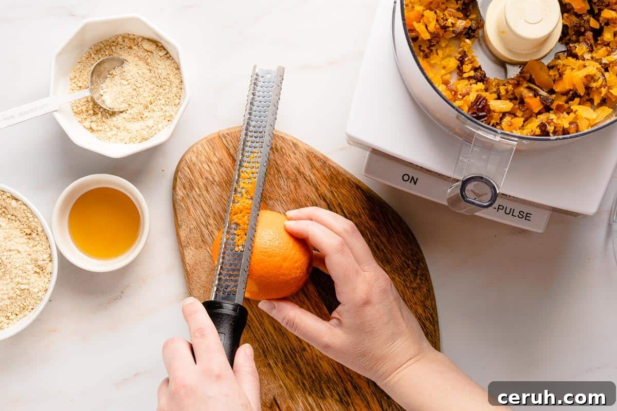 orange being zested with microplane