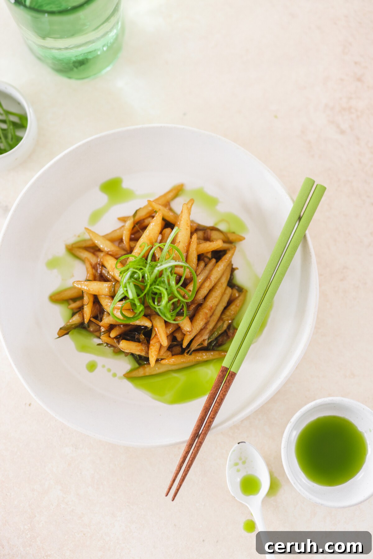 a white bowl of scallion oil noodles