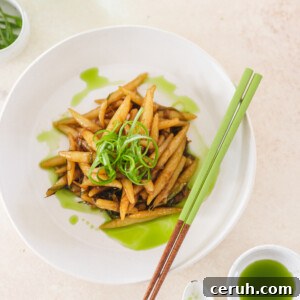 a white bowl of scallion oil noodles