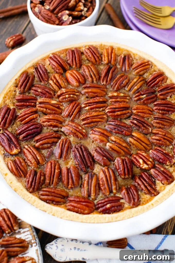 Homemade pecan pie topped with pecans.