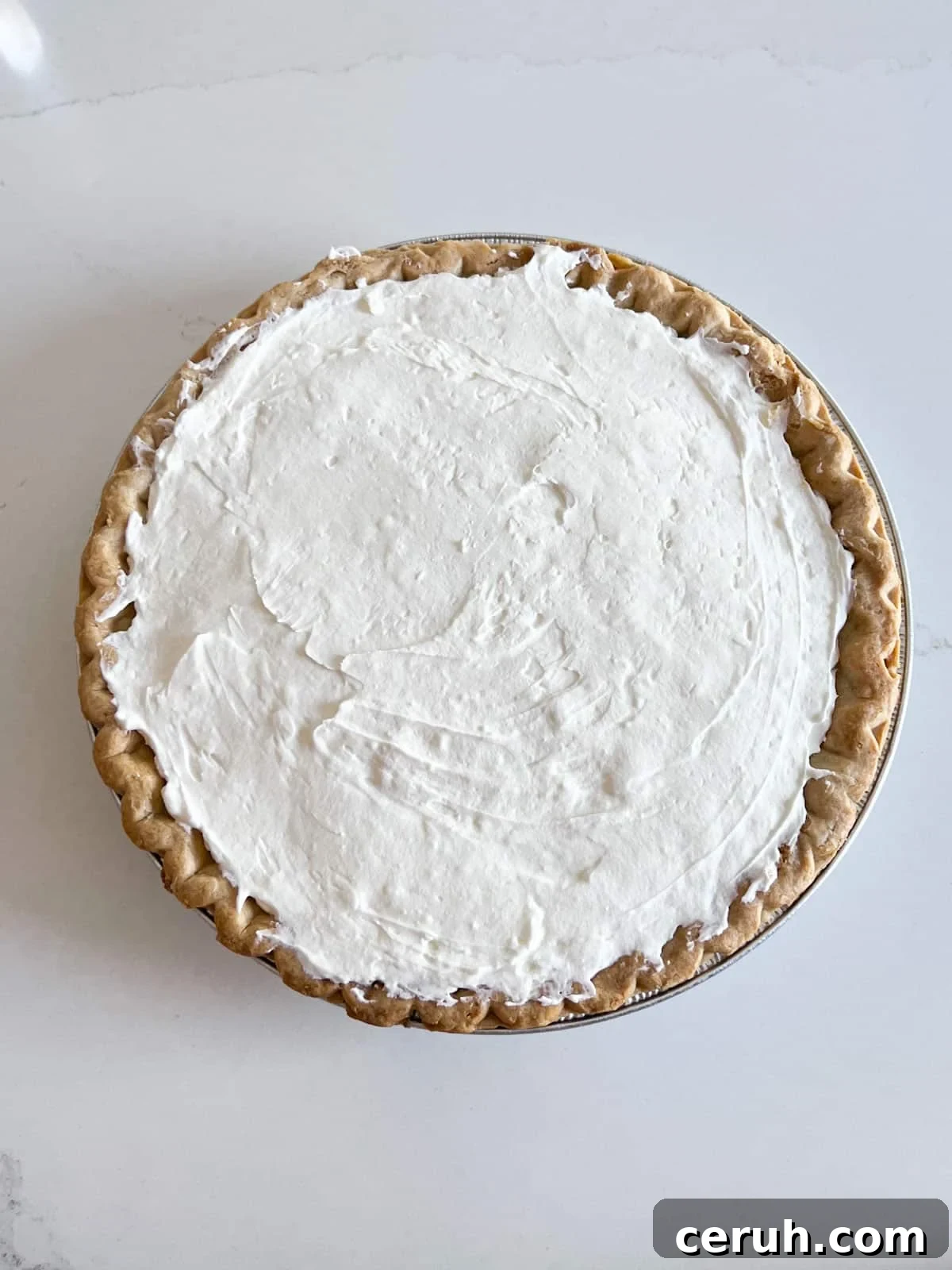 Cream cheese mixture spread in the baked pie shell.