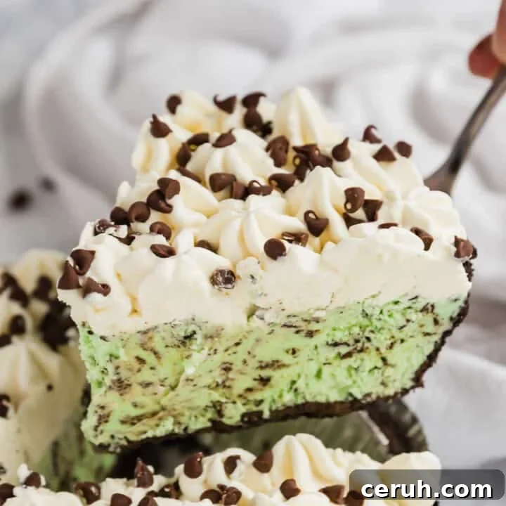 A piece of mint chip ice cream cake being lifted out of the pan.