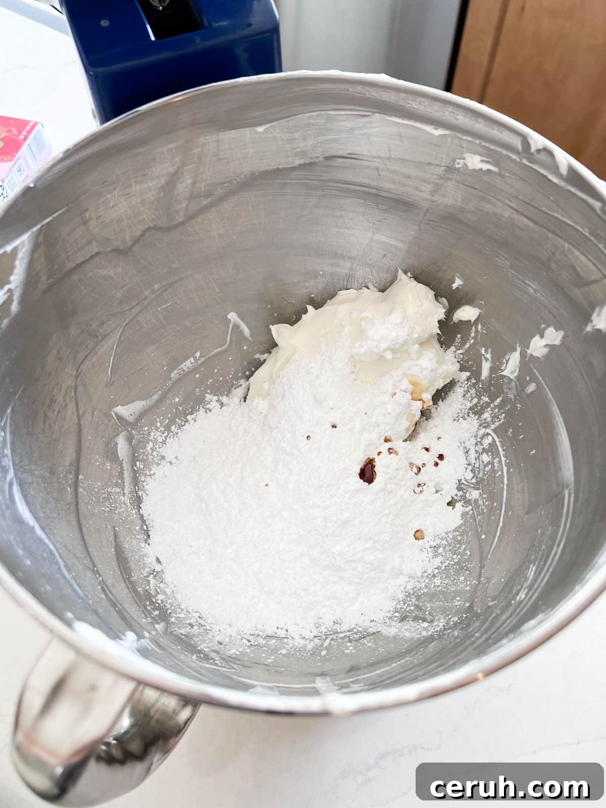 All cream cheese filling ingredients in a stand mixer bowl.