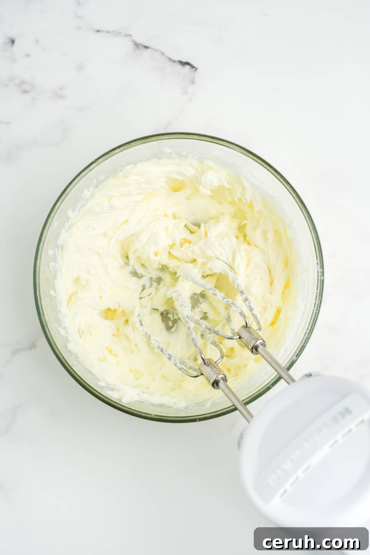 All of the ingredients being beat together with a mixer.