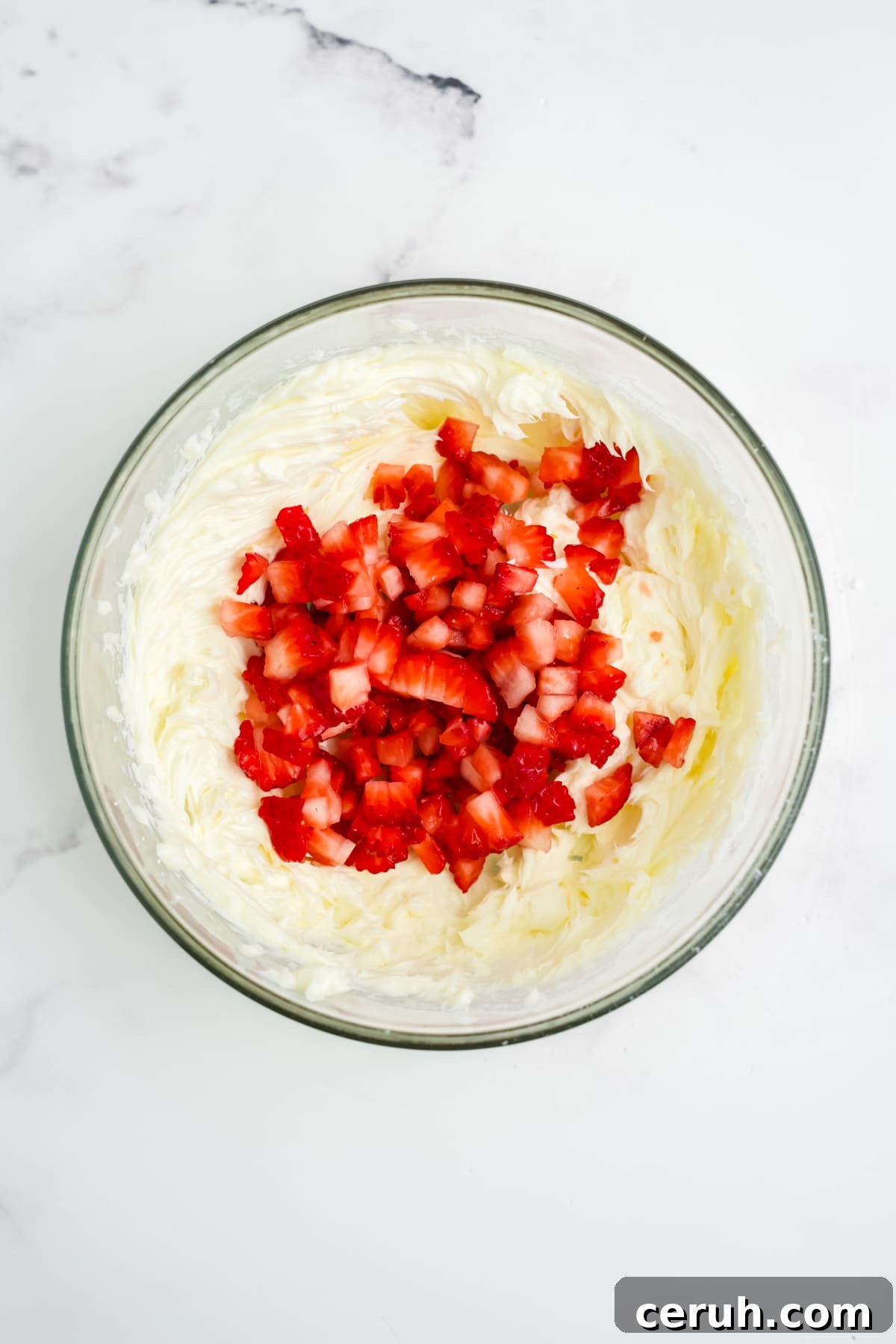 Diced strawberries added into the mixture.